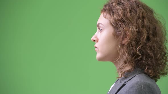Profile View of Young Beautiful Businesswoman with Curly Blond Hair
