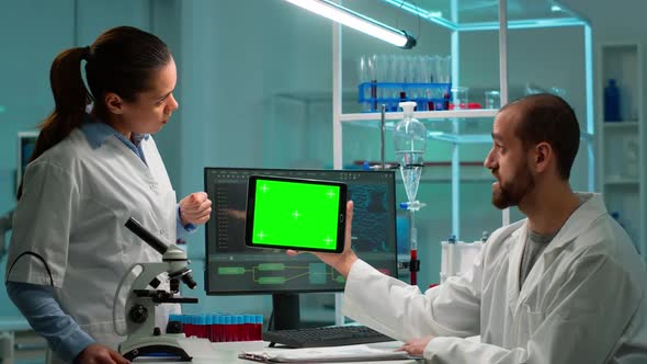 Scientists Using Tablet with Green Chroma Key Screen Talking