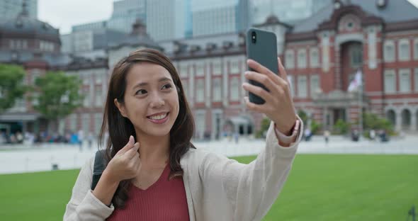 Woman travel in Tokyo and use of mobile phone at Tokyo station