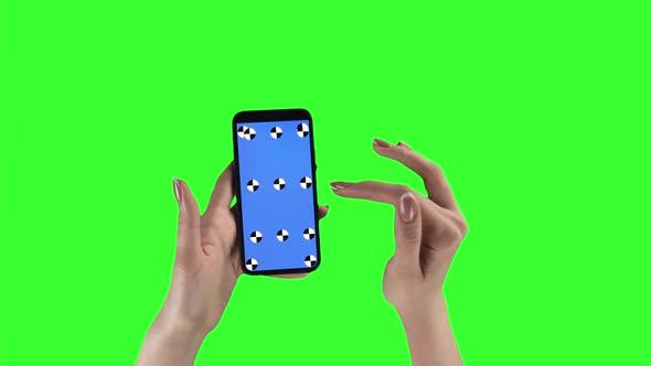 Closeup of Woman with Mobile Phone Zooming the Content By Fingers and Sliding It on Green Screen