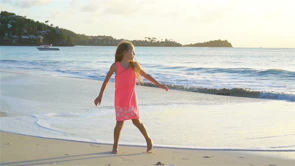 Adorable Active Little Girl on White Beach at Sunset, SLOW MOTION