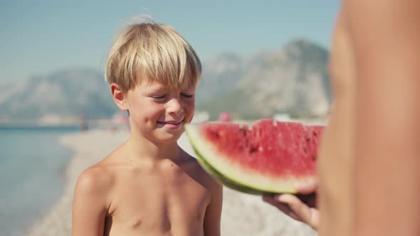 Boy Eating Watermelon on the Beach Summertime
