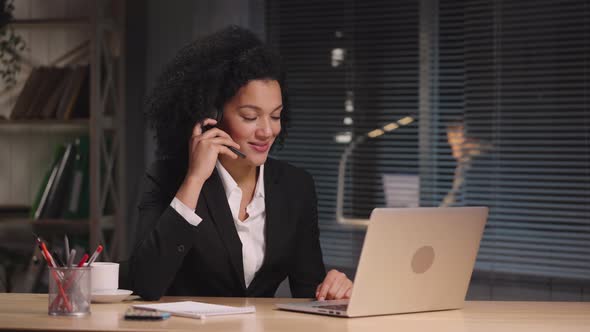 Portrait of African American Woman Wearing Headset Working to Support Remote Customer