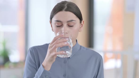 Portrait of Young Latin Woman Drinking Water