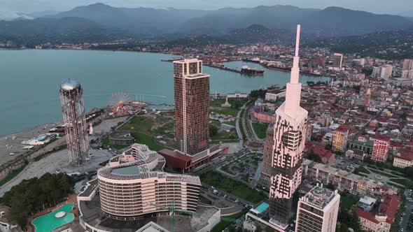 Aerial shot at sunset of modern buildings in downtown of Batumi. Georgia 2022 summer