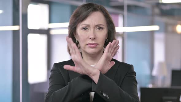 Portrait of Middle Aged Businesswoman Saying No with Hand Gesture