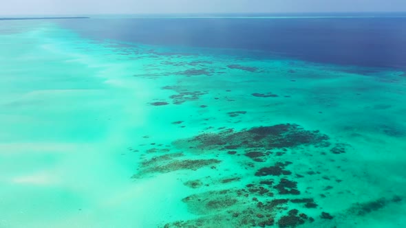 Aerial landscape of relaxing island beach lifestyle by blue lagoon and bright sandy background of a 