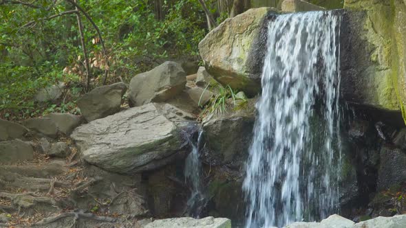 Water Flows Between Stones In the Forest