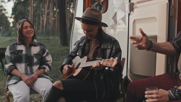 Woman Playing Ukulele During Camping Trip