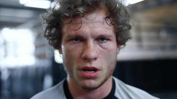 Tired Fighter Having Break in Fitness Center. Handsome Kickboxer Sweating at Gym