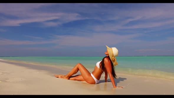 One woman posing on idyllic sea view beach voyage by transparent sea with white sandy background of 