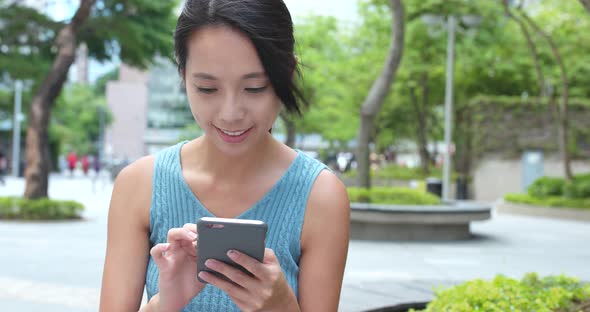 Woman Working on Cellphone at Outdoor 