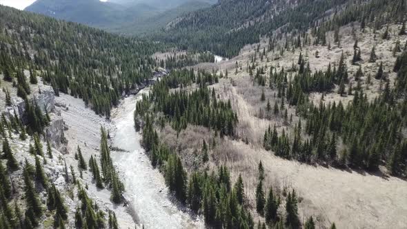 Aerial Footage Flying Down The Mountain Towards The Creek