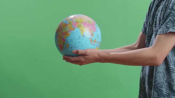 Side View Of A Man In Front Of Green Screen Background Extend The World Globe High