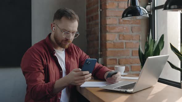 Man Typing Credit Card Number on His Mobile Phone Buying Items Online