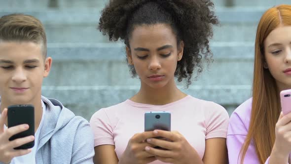 Caucasian and Mixed Race Teens Scrolling Smartphones, Gadget Addiction Concept
