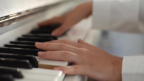 Extreme Closeup Hands of Unrecognizable Female Musician Performer Playing on Classical Piano at Home