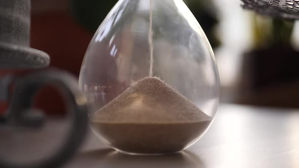 Hourglass sand falling in slow motion