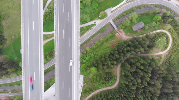 Aerial Top View of Highway Viaduct with Multilane Traffic in Mountains. Autobahn in Austria