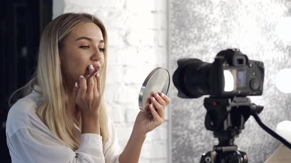 A Pretty Makeup Artist Is Applying Lipliner on Her Lips