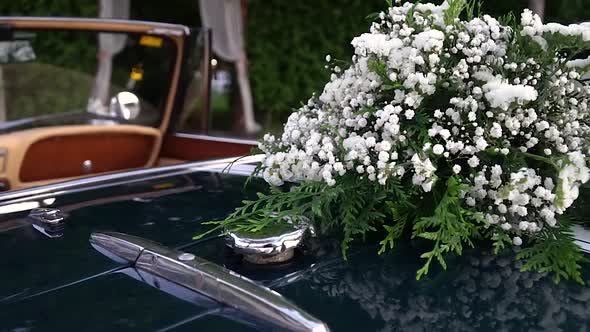 Wedding flower bouquet on convertible classic car, slide right