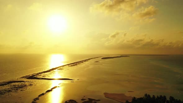 Beautiful birds eye tourism shot of a white sand paradise beach and aqua blue water background in hi