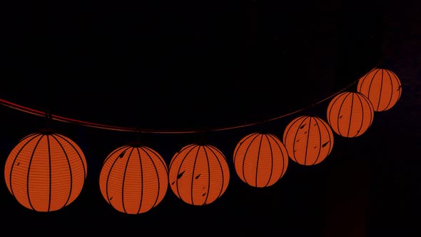 Halloween pumpkin garland hanging isolated on a black background