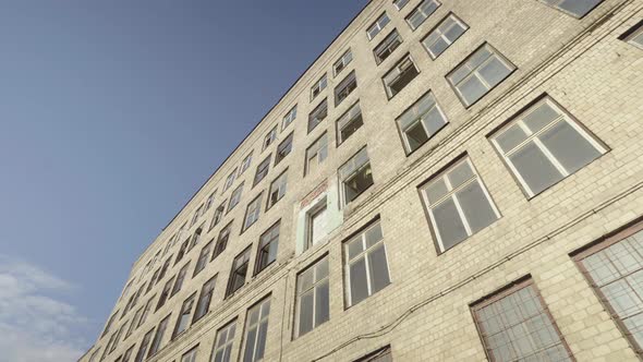 The old industrial building from the Soviet Union in very bad condition , with broken Windows