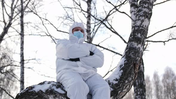 A Serious Look of a Man in a Protective Suit Against Diseases