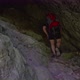 Hiker walking in a cave. People in nature concept. - VideoHive Item for Sale