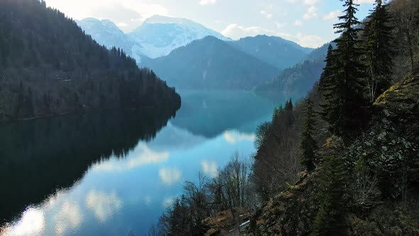 Clear Blue Mountain Lake with Reflection of Clouds on the Water