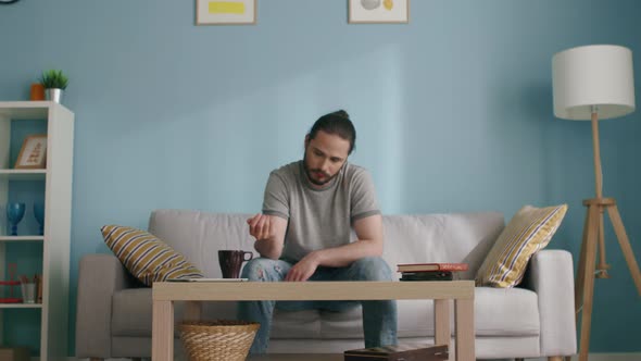 Man Throws Dice on Coffee Table