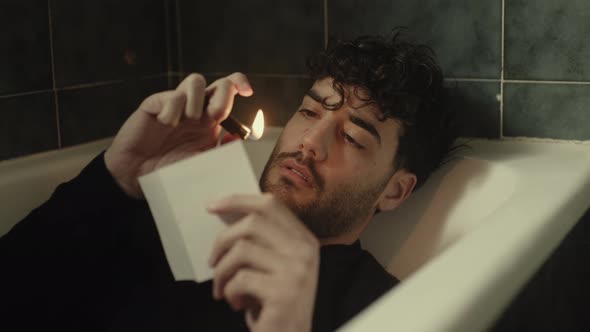 Boy in Bathtub Burns Photograph with Lighter