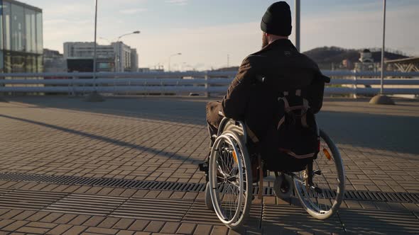 Wheelchairbound Man in City Equipment and Accessibility for Disability People in Modern Town