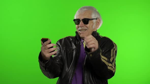 Elderly Stylish Caucasian Grandfather Man Using Smartphone for Online Shopping