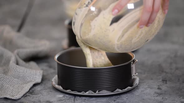  Pouring cake batter into cake molds