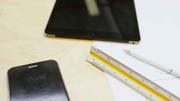 Mobile phone, digital tablet and pen on a table 4k