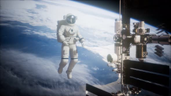 International Space Station and Astronaut in Outer Space Over the Planet Earth