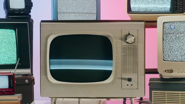 Old Televisions with Grey Interference Screen on Pink Red Neon Background