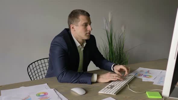 businessman working at the computer, typing on the keyboard
