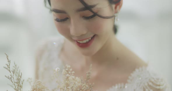 Slow Motion Smiling Beautiful Asian Bride In Wedding Dress With Flowers Bouquet.