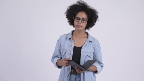 Young Beautiful African Woman with Eyeglasses Reading Book and Waving Hand