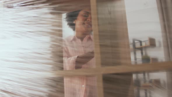 Happy Woman Packing Shelf and Moving to New Home