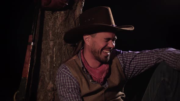 Cowboy Laughs in the Forest at Night