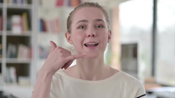 Portrait of Young Woman with Call Me Hand Gesture