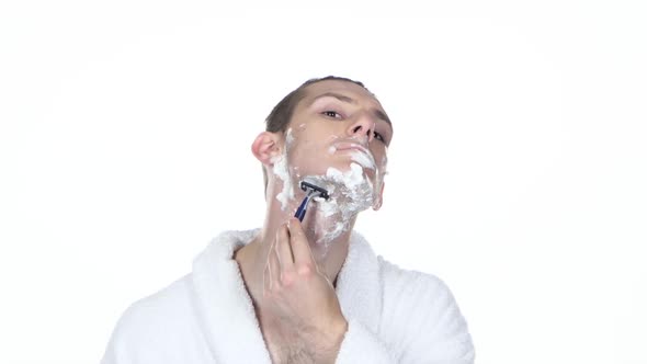 Young Guy Makes Morning's Procedure and Shaving. White Background