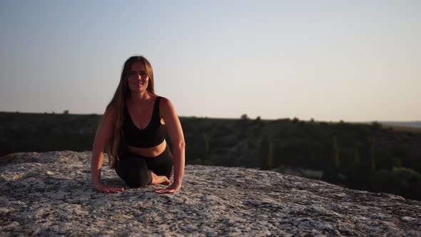 Young Woman with Long Hair Fitness Instructor in Black Sportswear Leggings and Tops Stretching