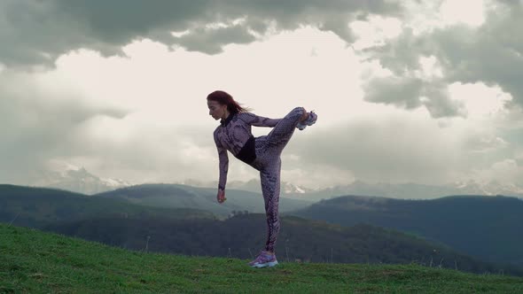 Athletic Woman Stretching Against Stunning Mountain Landscape