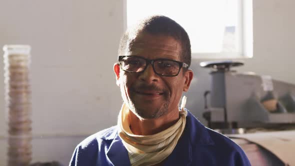 Front view of a mixed race worker in factory