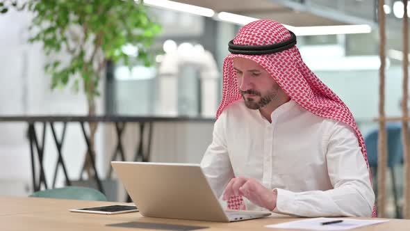 Serious Arab Businessman with Laptop Saying No with Finger Sign